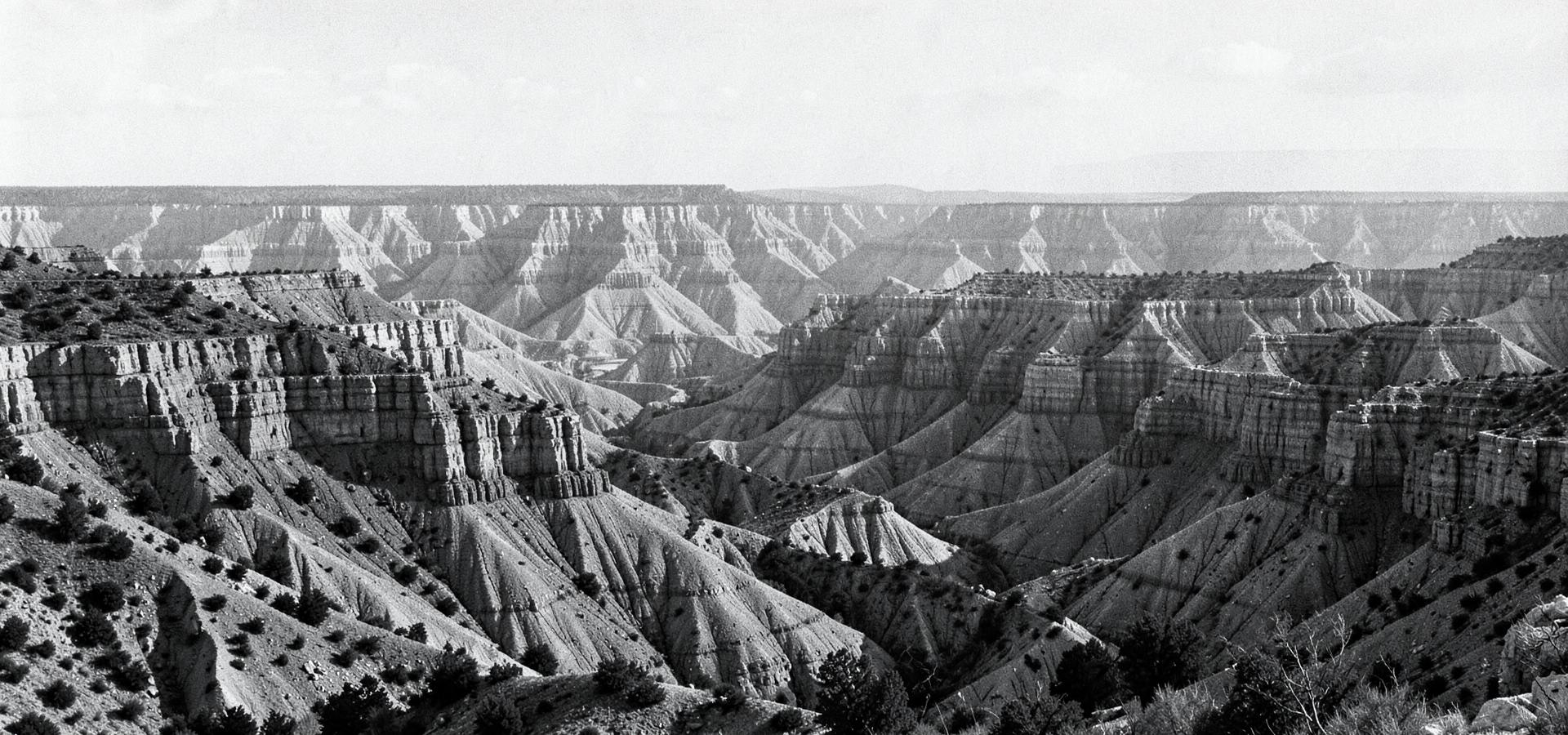 Layered strata and eroded buttes of the western North Dakota badlands in black and white